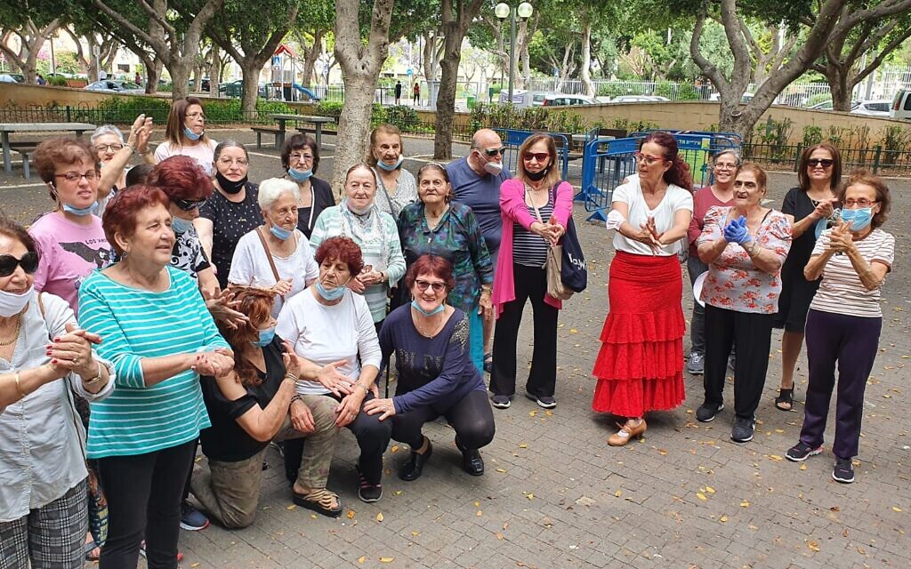 Participants in the Golden Gardens program clap for a speaker. (Yalya Galam/Iris Cohen/ via JTA)