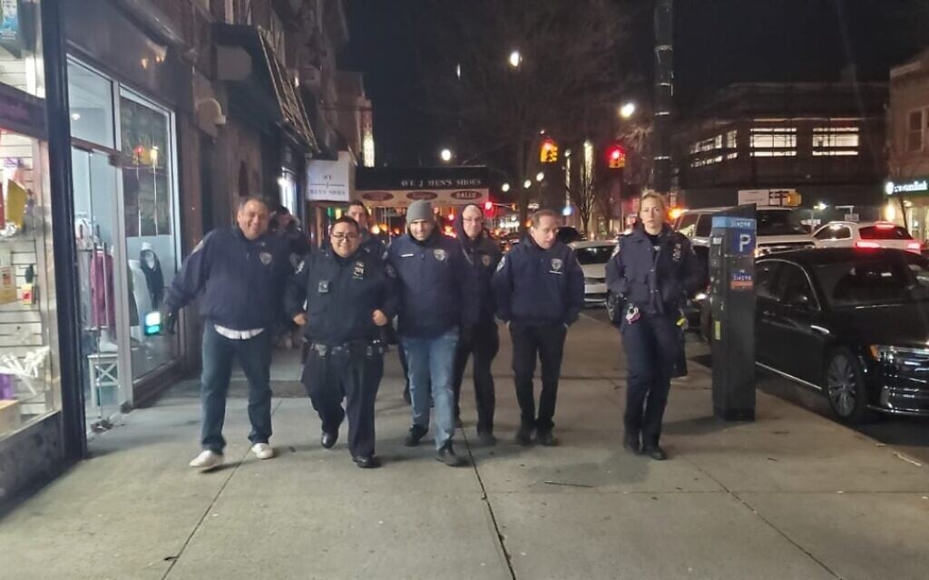 Executive coordinator for the Flatbush Shomrim Safety Patrol Bob Moskovitz, second from right, walks with NYPD officers in Flatbush, Brooklyn. (Courtesy)