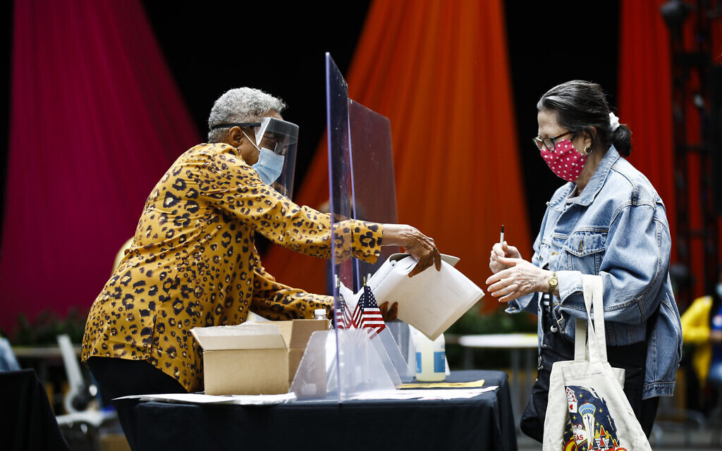 Illustrative: A voter, right, checks in with an election worker before casting her ballot in the Pennsylvania primary in Philadelphia, June 2, 2020. (AP Photo/Matt Rourke)
