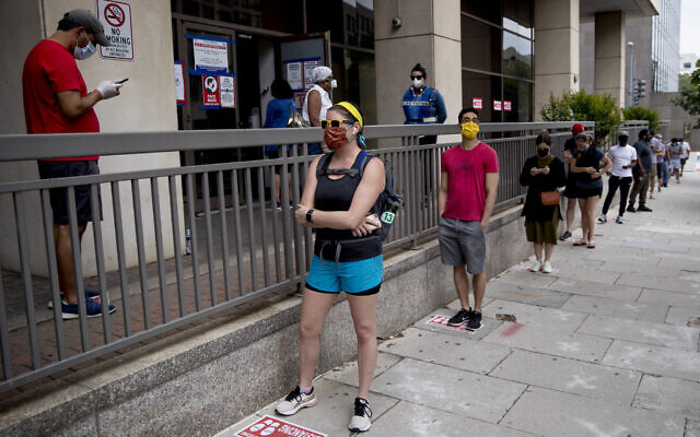 People wear masks as they wait in line to vote at a voting center during primary voting in Washington, Tuesday, June 2, 2020. (AP Photo/Andrew Harnik) People wear masks as they wait in line to vote at a voting center during primary voting in Washington, Tuesday, June 2, 2020. (AP Photo/Andrew Harnik)