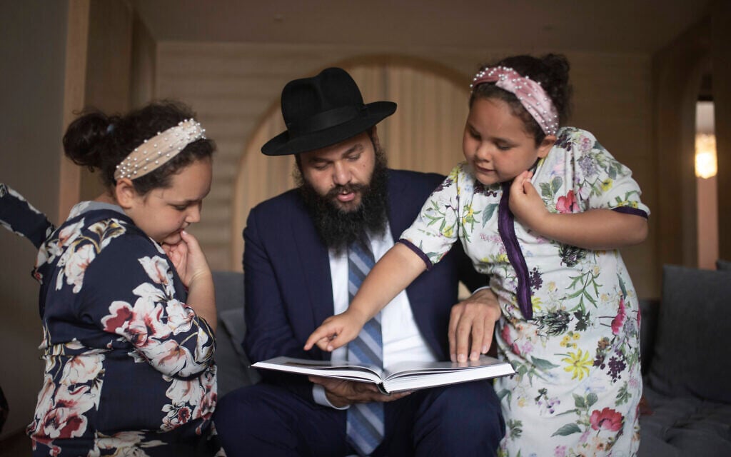 Rabbi Levi Banon and his daughters read a book inside their home in Casablanca, Morocco, May 28, 2020. (AP Photo/Mosa'ab Elshamy) Rabbi Levi Banon and his daughters read a book inside their home in Casablanca, Morocco, May 28, 2020. (AP Photo/Mosa'ab Elshamy)