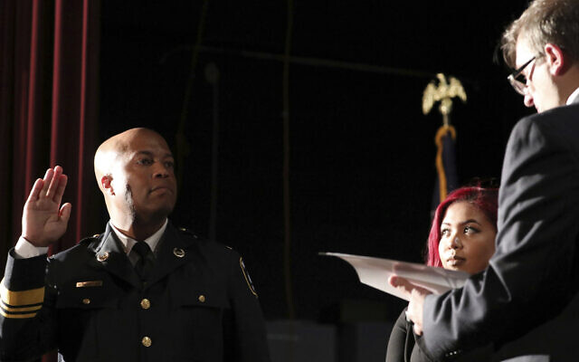 In this September 8, 2017, file photo, newly appointed Minneapolis Police Chief Medaria Arradondo takes the oath of office as his daughter Nyasia looks on during a public swearing-in ceremony, in Minneapolis. (Anthony Souffle/Star Tribune via AP, File)