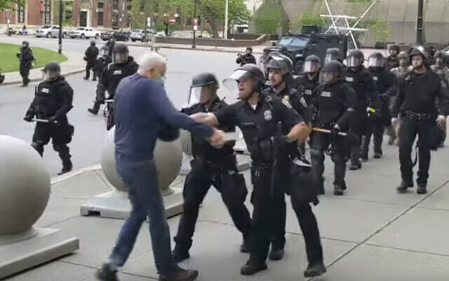 In this image from video provided by WBFO, a Buffalo police officer appears to shove a man who walked up to police Thursday, June 4, 2020, in Buffalo, N.Y. Video from WBFO shows the man appearing to hit his head on the pavement, with blood leaking out as officers walk past to clear Niagara Square. (Mike Desmond/WBFO via AP) In this image from video provided by WBFO, a Buffalo police officer appears to shove a man who walked up to police Thursday, June 4, 2020, in Buffalo, N.Y. Video from WBFO shows the man appearing to hit his head on the pavement, with blood leaking out as officers walk past to clear Niagara Square. (Mike Desmond/WBFO via AP)