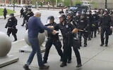 In this image from video provided by WBFO, a Buffalo police officer appears to shove a man who walked up to police on June 4, 2020, in Buffalo, New York. (Mike Desmond/WBFO via AP)