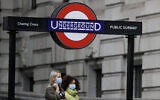 Pedestrians wear masks as they walk near Charing Cross Station in London, Friday, June 5, 2020. It will become compulsory to wear face coverings while using public transport in England from Monday June 15. (AP Photo/Kirsty Wigglesworth)