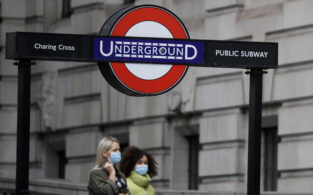 Pedestrians wear masks as they walk near Charing Cross Station in London, Friday, June 5, 2020. It will become compulsory to wear face coverings while using public transport in England from Monday June 15. (AP Photo/Kirsty Wigglesworth) Pedestrians wear masks as they walk near Charing Cross Station in London, Friday, June 5, 2020. It will become compulsory to wear face coverings while using public transport in England from Monday June 15. (AP Photo/Kirsty Wigglesworth)