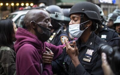 Illustrative: In this June 2, 2020, file photo, a protester and a police officer greet in the middle of a standoff during a solidarity rally calling for justice over the death of George Floyd in New York (AP Photo/Wong Maye-E, File)
