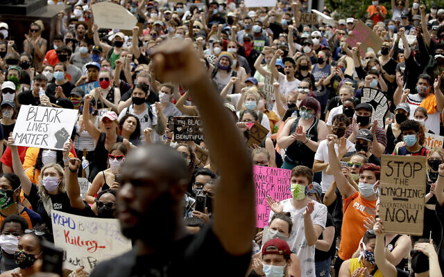 People hold signs as they listen to a speaker in front of city hall in downtown Kansas City, Missouri., Friday, June 5, 2020 (AP Photo/Charlie Riedel) People hold signs as they listen to a speaker in front of city hall in downtown Kansas City, Missouri., Friday, June 5, 2020 (AP Photo/Charlie Riedel)