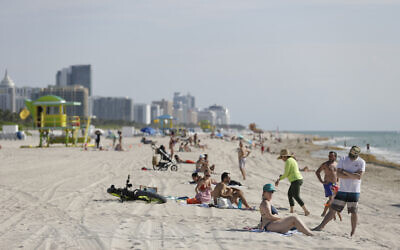 Beach goers in Miami-Dade County enjoy a day on the sand and in the water, on Wednesday, June 10, 2020 (AP Photo/Wilfredo Lee)