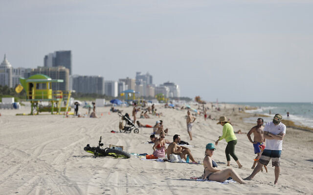 Beach goers in Miami-Dade County enjoy a day on the sand and in the water, on Wednesday, June 10, 2020 (AP Photo/Wilfredo Lee) Beach goers in Miami-Dade County enjoy a day on the sand and in the water, on Wednesday, June 10, 2020 (AP Photo/Wilfredo Lee)