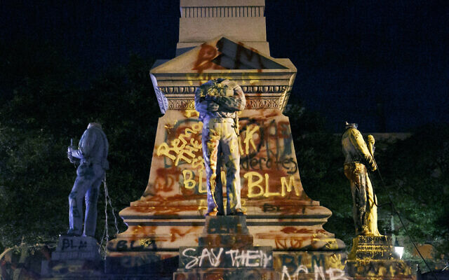 The statues on the Confederate monument are covered in graffiti and beheaded after a protest in Portsmouth, Virginia, on June 10, 2020 (Kristen Zeis/The Virginian-Pilot via AP) The statues on the Confederate monument are covered in graffiti and beheaded after a protest in Portsmouth, Virginia, on June 10, 2020 (Kristen Zeis/The Virginian-Pilot via AP)