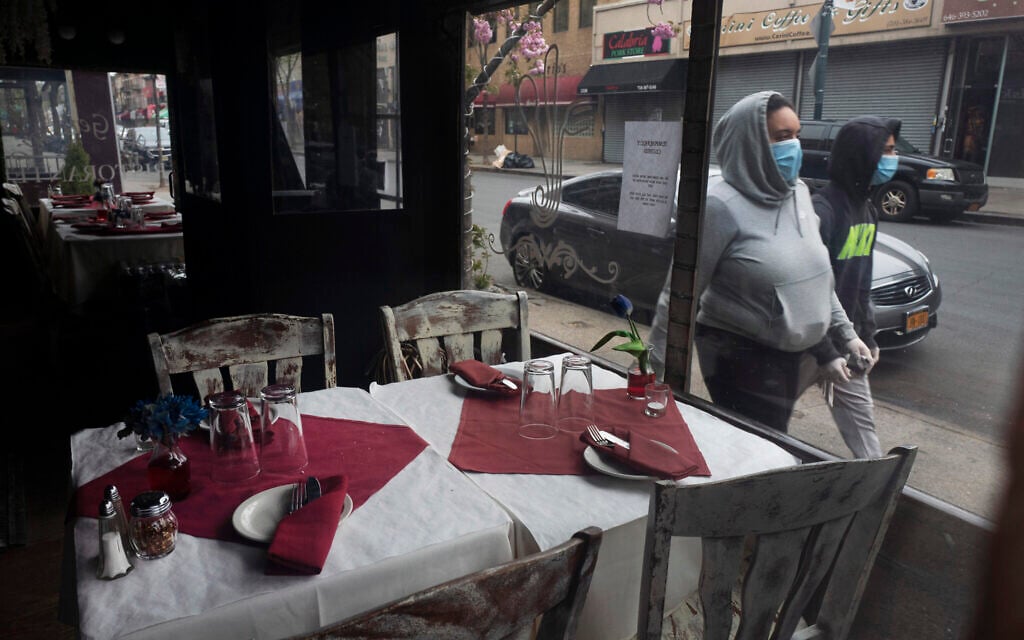 San Gennaro restaurant is closed but the tables are set in the Bronx borough of New York on Friday, April 17, 2020, during the coronavirus pandemic. (AP Photo/Mark Lennihan)