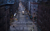 Bicyclists and a pedestrian pass through a quiet Manhattan street, March 26, 2020, during the coronavirus pandemic in New York. (AP Photo/Mark Lennihan)