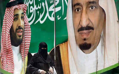 A woman walks past a banner showing Saudi King Salman, right, and his Crown Prince Mohammed bin Salman, outside a mall in Jiddah, Saudi Arabia, June 15, 2020. (AP Photo/Amr Nabil) A woman walks past a banner showing Saudi King Salman, right, and his Crown Prince Mohammed bin Salman, outside a mall in Jiddah, Saudi Arabia, June 15, 2020. (AP Photo/Amr Nabil)