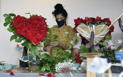 A florist prepares a floral arrangement on Mother's Day at the Los Angeles Flower Market in Los Angeles, on May 10, 2020. (AP Photo/Marcio Jose Sanchez, File)