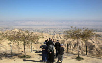 In this January 26, 2020, photo, Jewish settlers stand at a viewpoint overlooking the West Bank city of Jericho from the Jewish settlement of Mitzpe Yeriho (AP Photo/Oded Balilty)