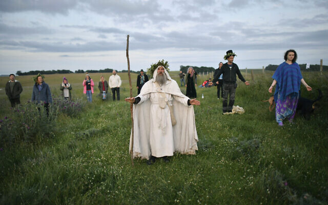 An Archdruid performs a ritual near the cordoned off Stonehenge as a small group of people gathered to celebrate the Summer Solstice, the longest day of the year, near Salisbury, England, June 21, 2020. (Ben Birchall/PA via AP) An Archdruid performs a ritual near the cordoned off Stonehenge as a small group of people gathered to celebrate the Summer Solstice, the longest day of the year, near Salisbury, England, June 21, 2020. (Ben Birchall/PA via AP)