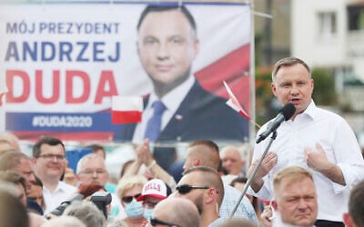 Polish President Andrzej Duda waves to supporters as he campaigns for a second term in Serock, Poland, June 17, 2020. (Czarek Sokolowski/AP)