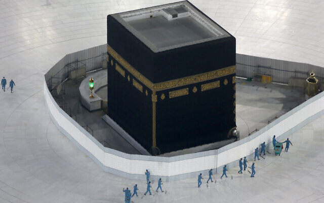 Workers disinfect the ground around the Kaaba, the cubic building at the Grand Mosque, in the Muslim holy city of Mecca, Saudi Arabia, on March 7, 2020. (Amr Nabil/ AP) Workers disinfect the ground around the Kaaba, the cubic building at the Grand Mosque, in the Muslim holy city of Mecca, Saudi Arabia, on March 7, 2020. (Amr Nabil/ AP)
