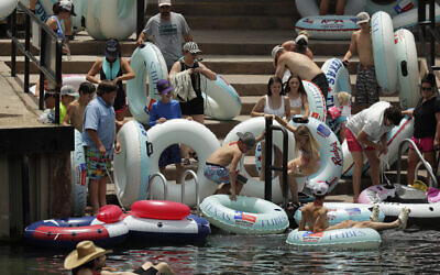 Tubers prepare to float the Comal River despite the recent spike in COVID-19 cases, Thursday, June 25, 2020, in New Braunfels, Texas. (AP Photo/Eric Gay) Tubers prepare to float the Comal River despite the recent spike in COVID-19 cases, Thursday, June 25, 2020, in New Braunfels, Texas. (AP Photo/Eric Gay)