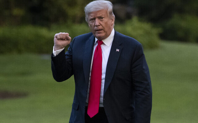 US President Donald Trump pumps his fist as he walks on the South Lawn after arriving on Marine One at the White House, Thursday, June 25, 2020, in Washington. Trump was returning from Wisconsin. (AP Photo/Alex Brandon) US President Donald Trump pumps his fist as he walks on the South Lawn after arriving on Marine One at the White House, Thursday, June 25, 2020, in Washington. Trump was returning from Wisconsin. (AP Photo/Alex Brandon)