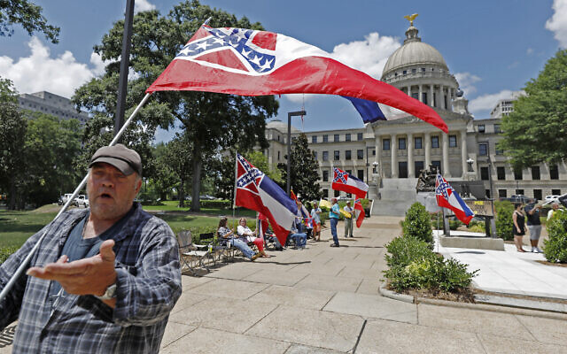 "I love this flag," states David Flynt of Hattiesburg, while standing outside the state Capitol with other current Mississippi flag supporters in Jackson, Miss., Sunday, June 28, 2020. Lawmakers in both chambers voted for state flag change legislation today. Mississippi Governor Tate Reeves has already said he would sign whatever flag bill the Legislature decides on. (AP Photo/Rogelio V. Solis) "I love this flag," states David Flynt of Hattiesburg, while standing outside the state Capitol with other current Mississippi flag supporters in Jackson, Miss., Sunday, June 28, 2020. Lawmakers in both chambers voted for state flag change legislation today. Mississippi Governor Tate Reeves has already said he would sign whatever flag bill the Legislature decides on. (AP Photo/Rogelio V. Solis)