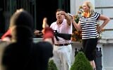 Armed homeowners standing in front their house along Portland Place confront protesters marching to St. Louis Mayor Lyda Krewson's house, June 28, 2020, in the Central West End of St. Louis. The protesters called for Krewson's resignation for releasing the names and addresses of residents who suggested defunding the police department. (Laurie Skrivan/St. Louis Post-Dispatch via AP)