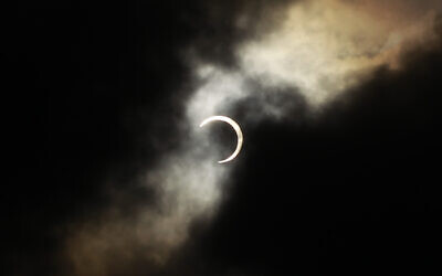 An annular solar eclipse is seen briefly during a break in clouds over Taipei, Taiwan, Monday, May 21, 2012. The annular solar eclipse, in which the moon passes in front of the sun leaving only a golden ring around its edges, was visible to wide areas across the continent.  (AP Photo/Wally Santana)