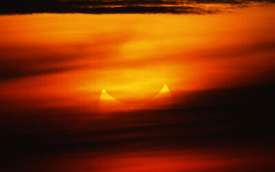 A "ring of fire" solar eclipse is partially seen at sunrise, May 21, 2012, from the coastal township of Gumaca, Quezon province, 187 kilometers (116 miles) southeast of Manila, Philippines. (AP Photo/Bullit Marquez)