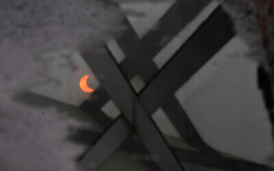 A partial annular solar eclipse is reflected in a pool of water in Beijing, China, Monday, May 21, 2012. (AP Photo/Ng Han Guan)