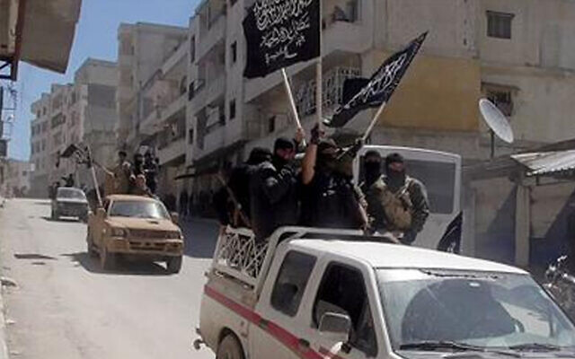 This 2015 image shows Nusra Front fighters standing on their vehicles and waving their group's flags as they tour the streets of Jisr al-Shughour, Idlib province, Syria (Al-Nusra Front Twitter page via AP) This 2015 image shows Nusra Front fighters standing on their vehicles and waving their group's flags as they tour the streets of Jisr al-Shughour, Idlib province, Syria (Al-Nusra Front Twitter page via AP)
