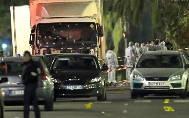 In this July 15, 2016, photo, forensic officers stand near a truck with its windscreen riddled with bullets that plowed through a crowd of revelers who had gathered to watch fireworks in the French resort city of Nice, southern France (AP Photo/Claude Paris, File) In this July 15, 2016, photo, forensic officers stand near a truck with its windscreen riddled with bullets that plowed through a crowd of revelers who had gathered to watch fireworks in the French resort city of Nice, southern France (AP Photo/Claude Paris, File)