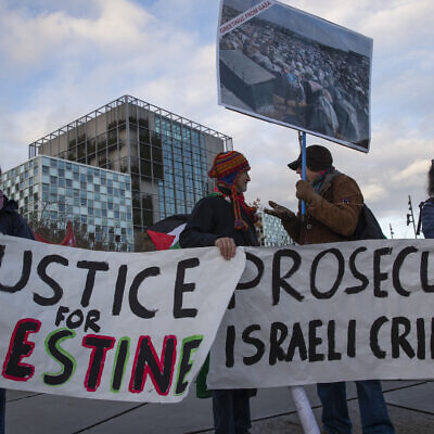 Demonstrators carry banners outside the International Criminal Court, urging the court to prosecute Israel's army for war crimes in The Hague, Netherlands, Friday, Nov. 29, 2019. (AP/Peter Dejong)