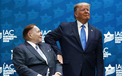 US President Donald Trump pats Las Vegas Sands Corporation Chief Executive and Republican mega donor Sheldon Adelson on the arm before speaking at the Israeli American Council National Summit in Hollywood, Florida, December 7, 2019. (Patrick Semansky/AP) US President Donald Trump pats Las Vegas Sands Corporation Chief Executive and Republican mega donor Sheldon Adelson on the arm before speaking at the Israeli American Council National Summit in Hollywood, Florida, December 7, 2019. (Patrick Semansky/AP)