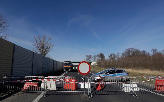 Polish policemen talk to a driver at the closed border crossing near Hradek nad Nisou, Czech Republic, March 15, 2020. (AP Photo/Petr David Josek) Polish policemen talk to a driver at the closed border crossing near Hradek nad Nisou, Czech Republic, March 15, 2020. (AP Photo/Petr David Josek)