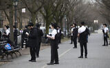 Illustrative: Orthodox Jewish men use social distancing as they pray outside the Chabad Lubavitch World Headquarters, Friday, March 20, 2020 in the Brooklyn borough of New York. (AP Photo/Mark Lennihan)