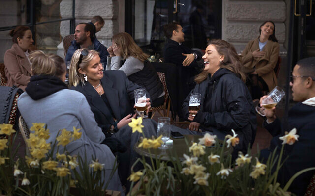 In this April 8, 2020, photo people chat and drink outside a bar in Stockholm, Sweden. Sweden is pursuing relatively liberal policies to fight the coronavirus pandemic, even though there has been a sharp spike in deaths. (AP Photo/Andres Kudacki, File) In this April 8, 2020, photo people chat and drink outside a bar in Stockholm, Sweden. Sweden is pursuing relatively liberal policies to fight the coronavirus pandemic, even though there has been a sharp spike in deaths. (AP Photo/Andres Kudacki, File)