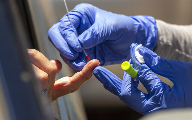 Illustrative: A health worker takes a blood sample for a COVID-19 antibody test in Los Angeles, May 20, 2020. (AP Photo/Damian Dovarganes) Illustrative: A health worker takes a blood sample for a COVID-19 antibody test in Los Angeles, May 20, 2020. (AP Photo/Damian Dovarganes)