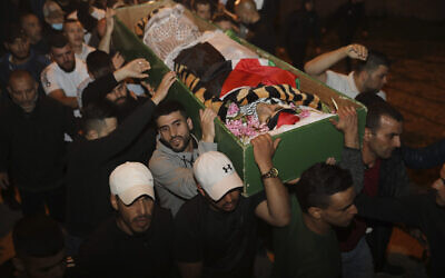 Men carry the body of Iyad Halak to burial after Israeli police shot him dead in Jerusalem's Old City, Sunday, May 31, 2020, believing he was carrying a gun. Israel's defense minister has apologized for the shooting of the unarmed Palestinian, who was autistic. (AP Photo/Mahmoud Illean)