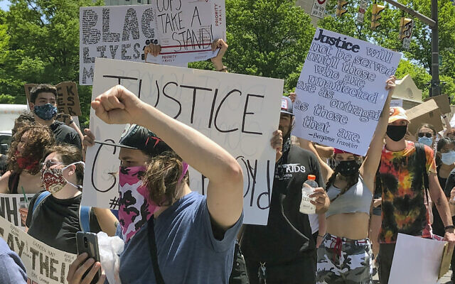Protesters march past the Ohio Statehouse on Tuesday, June 2, 2020, in Columbus, Ohio, against the death of George Floyd, who died after being restrained by Minneapolis police officers on Memorial Day, May 25. (AP Photo/Andrew Welsh-Huggins) Protesters march past the Ohio Statehouse on Tuesday, June 2, 2020, in Columbus, Ohio, against the death of George Floyd, who died after being restrained by Minneapolis police officers on Memorial Day, May 25. (AP Photo/Andrew Welsh-Huggins)