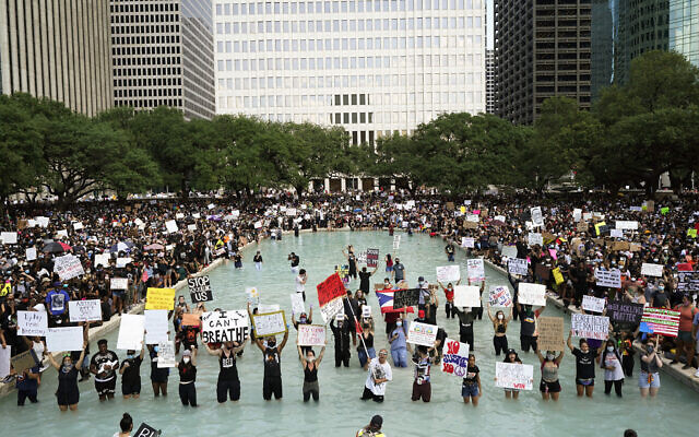 People rally to protest the death of George Floyd in Houston on Tuesday, June 2, 2020. (AP Photo/David J. Phillip)