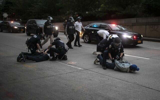 Police arrest protesters refusing to get off the streets during an imposed curfew while marching in a rally calling for justice over the death of George Floyd Tuesday, June 2, 2020, in New York. Floyd died after being restrained by Minneapolis police officers on May 25. (AP Photo/Wong Maye-E)