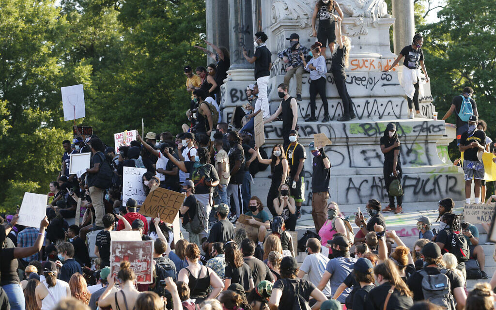 FILE - This Tuesday, June 2, 2020 file photo shows a large group of protesters gather around the statue of Confederate General Robert E. Lee on Monument Avenue near downtown in Richmond, Va. Virginia Gov. Ralph Northam announced plans Thursday, June 4, for the removal of the iconic statue. (AP Photo/Steve Helber, File)