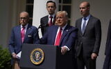 US President Donald Trump speaks during a news conference in the Rose Garden of the White House, Friday, June 5, 2020, in Washington. White House chief economic adviser Larry Kudlow, left, and Labor Secretary Eugene Scalia, top right listen. (AP Photo/Evan Vucci)