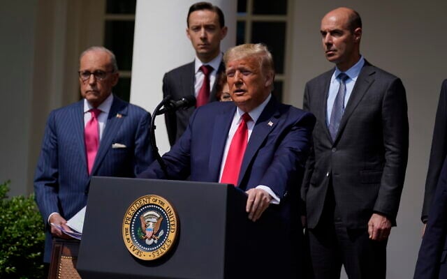 US President Donald Trump speaks during a news conference in the Rose Garden of the White House, Friday, June 5, 2020, in Washington. White House chief economic adviser Larry Kudlow, left, and Labor Secretary Eugene Scalia, top right listen. (AP Photo/Evan Vucci) US President Donald Trump speaks during a news conference in the Rose Garden of the White House, Friday, June 5, 2020, in Washington. White House chief economic adviser Larry Kudlow, left, and Labor Secretary Eugene Scalia, top right listen. (AP Photo/Evan Vucci)