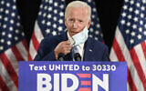 Democratic US presidential candidate, former vice president Joe Biden, takes off his mask before speaking during an event in Dover, Delaware, June 5, 2020. (AP Photo/Susan Walsh)
