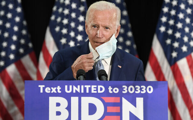 Democratic US presidential candidate, former vice president Joe Biden, takes off his mask before speaking during an event in Dover, Delaware, June 5, 2020. (AP Photo/Susan Walsh) Democratic US presidential candidate, former vice president Joe Biden, takes off his mask before speaking during an event in Dover, Delaware, June 5, 2020. (AP Photo/Susan Walsh)