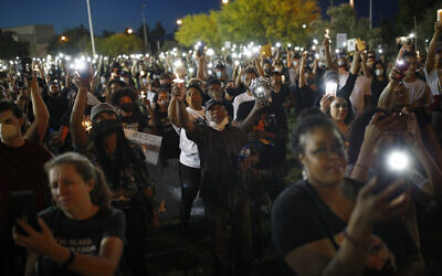 People hold up candles and cell phone lights during a rally June 5, 2020, in Las Vegas, against police brutality sparked by the death of George Floyd, a black man who died after being restrained by Minneapolis police officers on May 25. (AP Photo/John Locher)