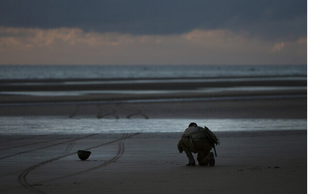 A man in a vintage US WWII uniform kneels at sunrise prior to a D-Day 76th anniversary ceremony in Saint Laurent sur Mer, Normandy, France, June 6, 2020 (AP Photo/Virginia Mayo) A man in a vintage US WWII uniform kneels at sunrise prior to a D-Day 76th anniversary ceremony in Saint Laurent sur Mer, Normandy, France, June 6, 2020 (AP Photo/Virginia Mayo)