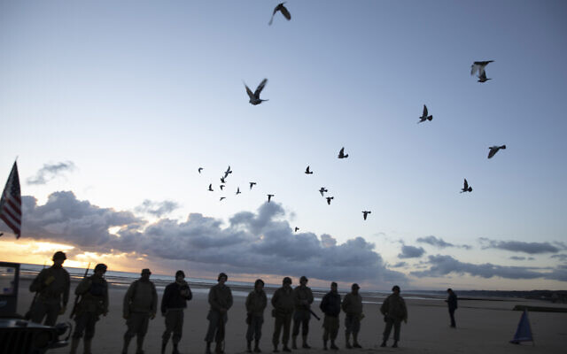 Men in a vintage US WWII uniform watch as pigeons are released during a D-Day 76th anniversary ceremony in Saint Laurent sur Mer, Normandy, France, June 6, 2020 (AP Photo/Virginia Mayo)